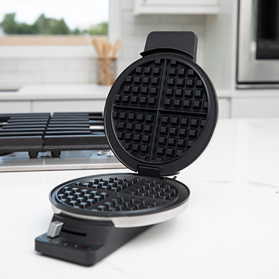 CUISINART<sup>&reg;</sup> Round Classic Waffle Maker - Enjoy delicious waffles with this stainless steel waffle maker.  With nonstick plates, five browning settings, a weighted lid, and dual indicator lights you can create restaurant-quality results right at home.  Measures: 7.88" x 9.69" x 3.31".